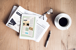 Press page cover image with newspapers on a desk